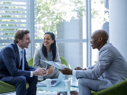 three people engaged in a business conversation